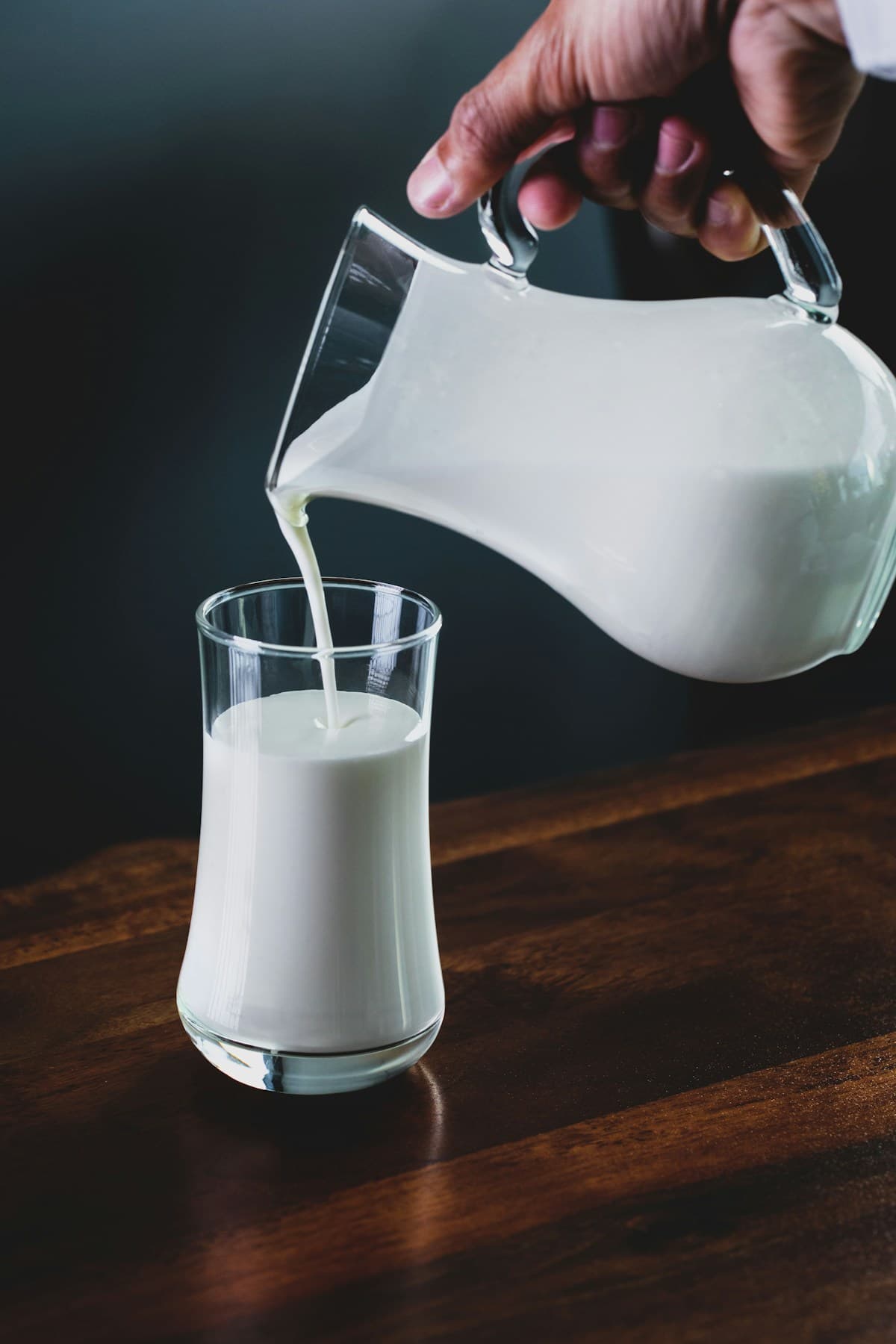 Fresh dairy milk being poured into a glass